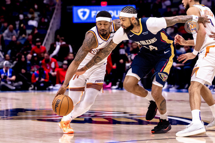 Dec 5, 2024; New Orleans, Louisiana, USA;  New Orleans Pelicans forward Brandon Ingram (14) reaches in to knock the ball loose against Phoenix Suns guard Bradley Beal (3) during the second half  at Smoothie King Center. Credit: Stephen Lew-Imagn Images