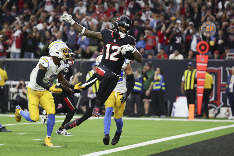 Jan 11, 2025; Houston, Texas, USA;  Houston Texans wide receiver Nico Collins (12) scores a touchdown against the Los Angeles Chargers in the second quarter in an AFC wild card game at NRG Stadium. Credit: Thomas Shea-Imagn Images