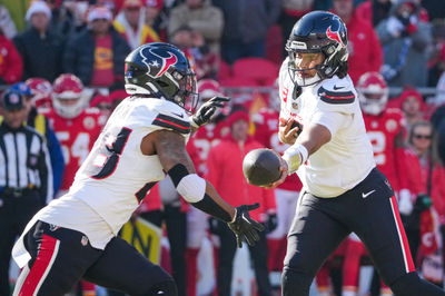 Dec 21, 2024; Kansas City, Missouri, USA; Houston Texans quarterback C.J. Stroud (7) hands off to running back Joe Mixon (28) against the Kansas City Chiefs during the first half at GEHA Field at Arrowhead Stadium. Mandatory Credit: Denny Medley-Imagn Images