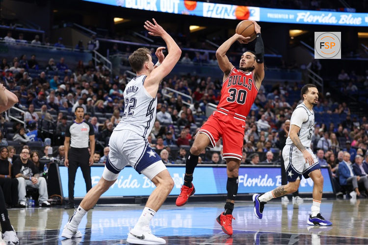Mar 6, 2025; Orlando, Florida, USA; Chicago Bulls guard Tre Jones (30) shoots the ball over Orlando Magic forward Franz Wagner (22) in the third quarter at Kia Center. Credit: Nathan Ray Seebeck-Imagn Images