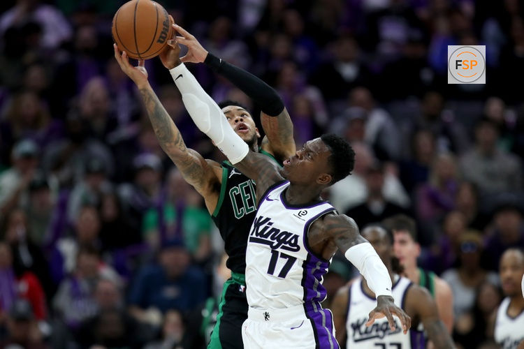 Jan 1, 2026; Sacramento, California, USA; Sacramento Kings guard Dennis Schroder (17) and Boston Celtics guard Anfernee Simons (4) battle for a rebound during the third quarter at Golden 1 Center. Credit: Dennis Lee-Imagn Images