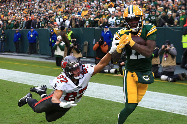 GREEN BAY, WI - DECEMBER 17: Green Bay Packers wide receiver Jayden Reed (11) catches a ball while Tampa Bay Buccaneers cornerback Zyon McCollum (27) tries to knock it away during a game between the Green Bay Packers and the Tampa Bay Buccaneers at Lambeau Field on December 17, 2023 in Green Bay, WI. (Photo by Larry Radloff/Icon Sportswire)