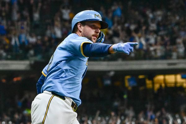 Sep 27, 2024; Milwaukee, Wisconsin, USA;  Milwaukee Brewers first baseman Rhys Hoskins (12) reacts after hitting a grand slam home run against the New York Mets in the first inning at American Family Field. Mandatory Credit: Benny Sieu-Imagn Images
