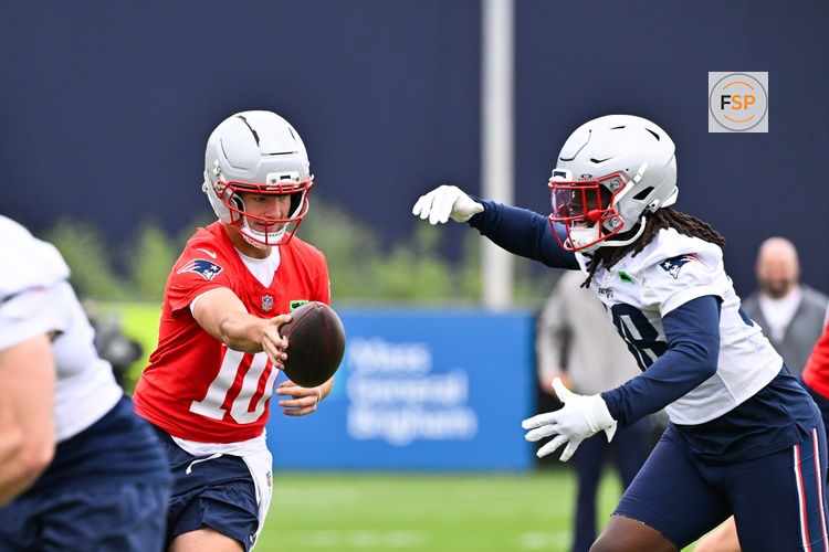 Jun 9, 2025; Foxborough, MA, USA; New England Patriots quarterback Drake Maye (10) hands the ball to running back Rhamondre Stevenson (38) during minicamp at Gillette Stadium. Credit: Eric Canha-Imagn Images