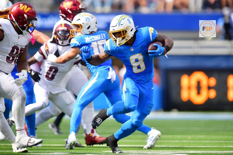 Oct 5, 2025; Inglewood, California, USA; Los Angeles Chargers running back Omarion Hampton (8) runs against Washington Commanders defensive tackle Jer'Zhan Newton (95) in the first half at SoFi Stadium. Credit: Gary A. Vasquez-Imagn Images