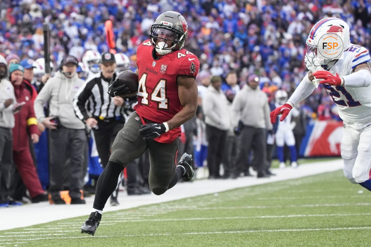 Nov 16, 2025; Orchard Park, New York, USA;  Tampa Bay Buccaneers running back Sean Tucker (44) runs the ball for a touchdown against Buffalo Bills safety Jordan Poyer (21) during the second half of the game at Highmark Stadium. Credit: Gregory Fisher-Imagn Images