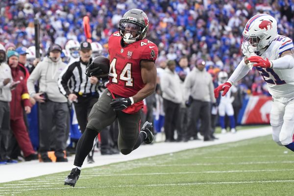 Nov 16, 2025; Orchard Park, New York, USA;  Tampa Bay Buccaneers running back Sean Tucker (44) runs the ball for a touchdown against Buffalo Bills safety Jordan Poyer (21) during the second half of the game at Highmark Stadium. Mandatory Credit: Gregory Fisher-Imagn Images