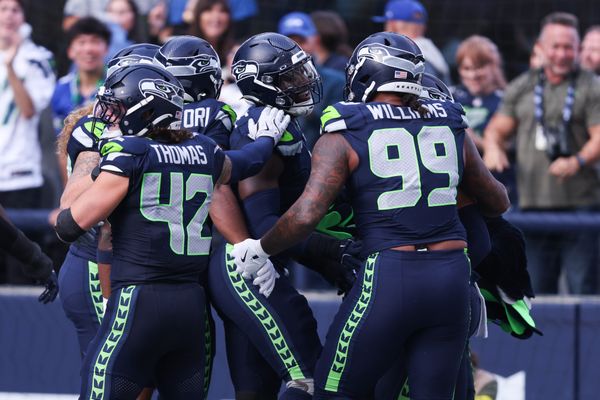 Nov 9, 2025; Seattle, Washington, USA; Seattle Seahawks defensive end DeMarcus Lawrence (0) celebrates with Seattle Seahawks defensive end Leonard Williams (99) and Seattle Seahawks linebacker Drake Thomas (42) after recovering a fumble to score a touchdown during the second quarter against the Arizona Cardinals at Lumen Field. Mandatory Credit: Kevin Ng-Imagn Images
