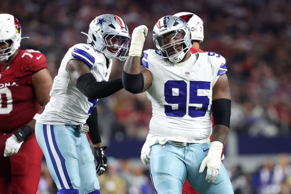 Nov 3, 2025; Arlington, Texas, USA; Dallas Cowboys defensive tackle Kenny Clark (95) and defensive end Donovan Ezeiruaku (41) celebrate after a sack Arizona Cardinals quarterback Jacoby Brissett (7) in the second half at AT&T Stadium. Mandatory Credit: Kevin Jairaj-Imagn Images