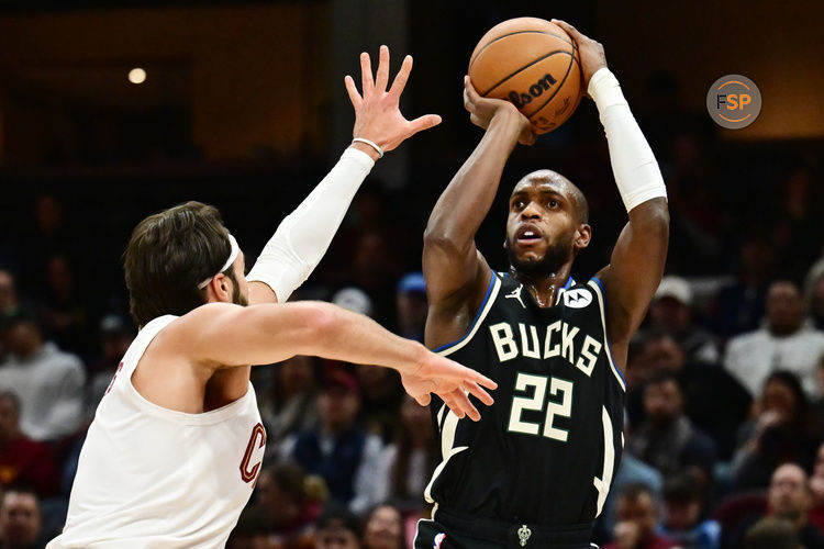 Dec 20, 2024; Cleveland, Ohio, USA; Milwaukee Bucks forward Khris Middleton (22) shoots over the defense of  Cleveland Cavaliers guard Max Strus (1) during the first half at Rocket Mortgage FieldHouse. Credit: Ken Blaze-Imagn Images