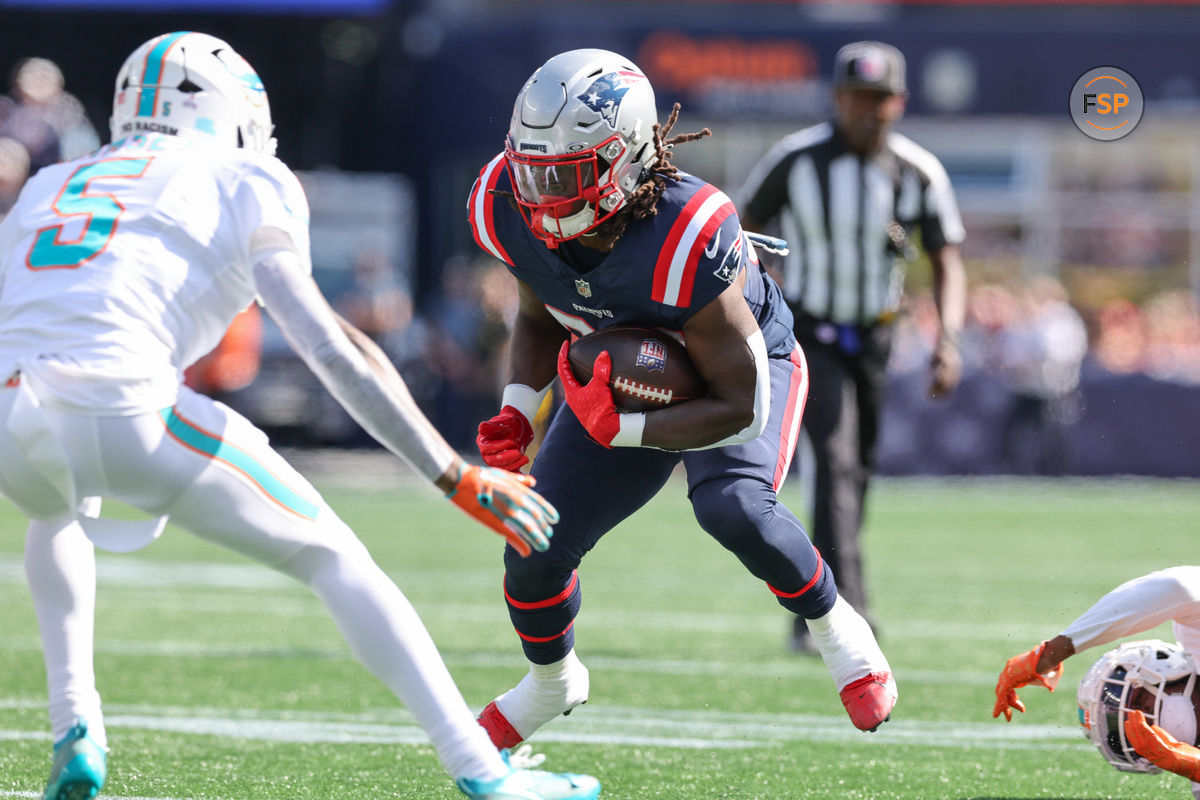 Oct 6, 2024; Foxborough, Massachusetts, USA; New England Patriots running back Rhamondre Stevenson (38) runs the ball during the first half against the Miami Dolphins at Gillette Stadium. Credit: Paul Rutherford-Imagn Images