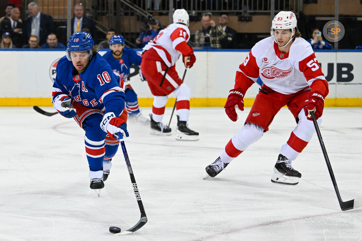 Oct 14, 2024; New York, New York, USA;  New York Rangers left wing Artemi Panarin (10) reaches for a loose puck while defended by Detroit Red Wings defenseman Moritz Seider (53) during the first period at Madison Square Garden. Credit: Dennis Schneidler-Imagn Images