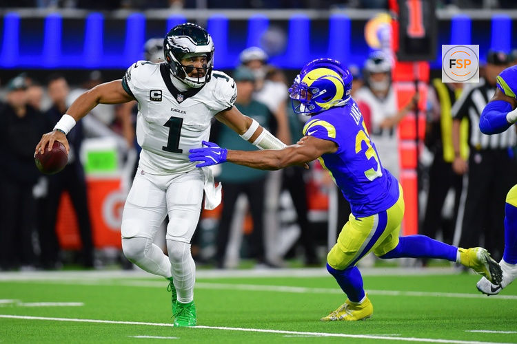 Nov 24, 2024; Inglewood, California, USA; Philadelphia Eagles quarterback Jalen Hurts (1) runs the ball against Los Angeles Rams safety Quentin Lake (37) during the first half at SoFi Stadium. Credit: Gary A. Vasquez-Imagn Images