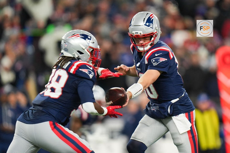 Jan 11, 2026; Foxborough, MA, USA; New England Patriots quarterback Drake Maye (10) hands the ball off to New England Patriots running back Rhamondre Stevenson (38) during the first quarter against the Los Angeles Chargers in an AFC Wild Card Round game at Gillette Stadium. Credit: David Butler II-Imagn Images