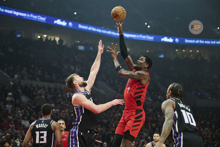 Feb 6, 2025; Portland, Oregon, USA;Portland Trail Blazers center Deandre Ayton (2) shoots a jump shot the ball during the first half against Sacramento Kings forward Domantas Sabonis (11) at Moda Center. Credit: Troy Wayrynen-Imagn Images