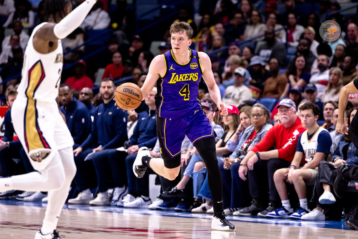 Nov 16, 2024; New Orleans, Louisiana, USA; Los Angeles Lakers guard Dalton Knecht (4) brings the ball up court against the New Orleans Pelicans during the first half at Smoothie King Center. Credit: Stephen Lew-Imagn Images