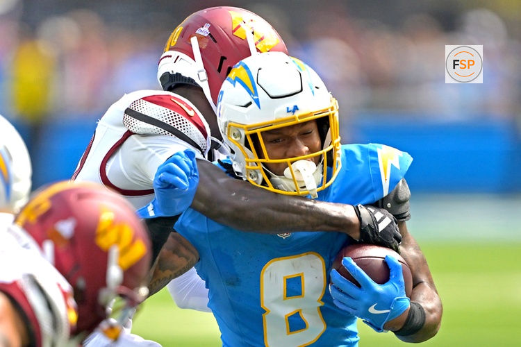 Oct 5, 2025; Inglewood, California, USA; Los Angeles Chargers running back Omarion Hampton (8) is stopped by Washington Commanders safety Quan Martin (20) at SoFi Stadium. Credit: Jayne Kamin-Oncea-Imagn Images