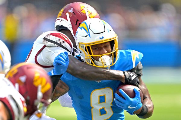 Oct 5, 2025; Inglewood, California, USA; Los Angeles Chargers running back Omarion Hampton (8) is stopped by Washington Commanders safety Quan Martin (20) at SoFi Stadium. Mandatory Credit: Jayne Kamin-Oncea-Imagn Images