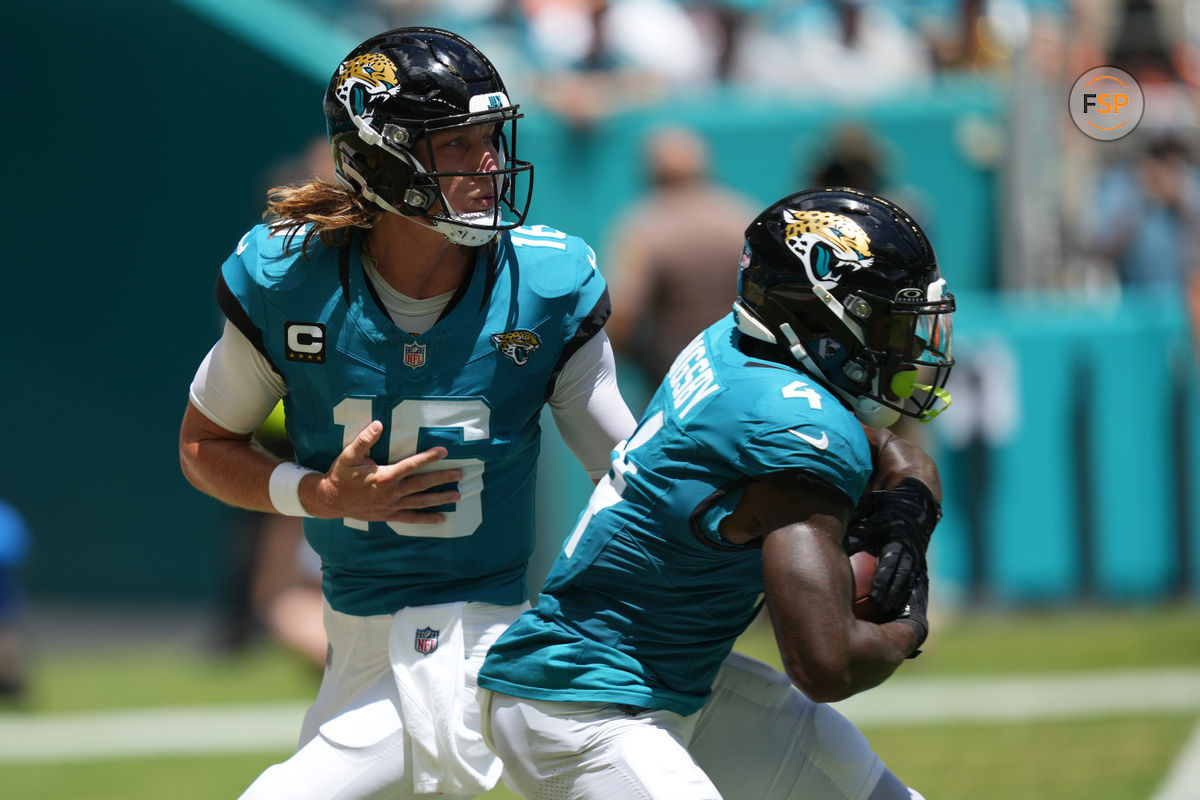 Sep 8, 2024; Miami Gardens, Florida, USA;  Jacksonville Jaguars quarterback Trevor Lawrence (16) hands off to running back Tank Bigsby (4) in the first quarter against the Miami Dolphins at Hard Rock Stadium. Credit: Jim Rassol-Imagn Images