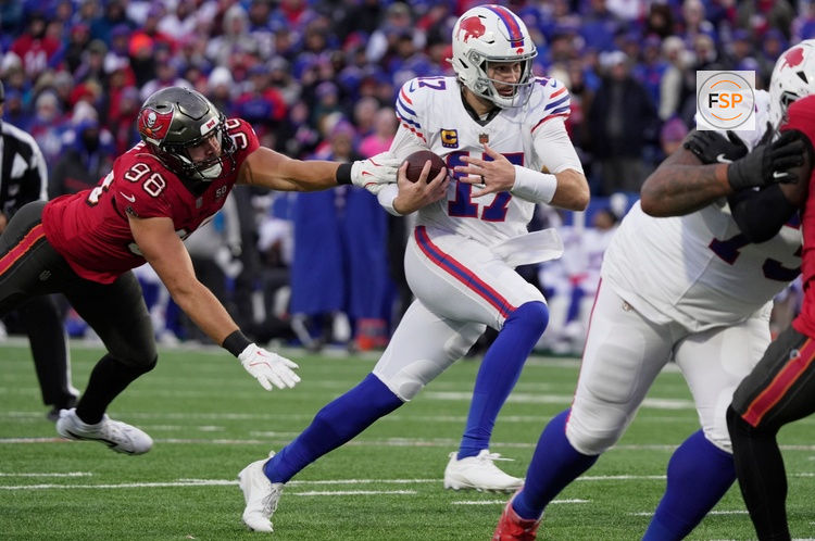 Buffalo Bills quarterback Josh Allen avoids Tampa Bay Buccaneers linebacker Anthony Nelson and runs for his third touchdown of the game during second half action against the Tampa Bay Buccaneers on Nov 16, 2025 at Highmark Stadium in Orchard Park.