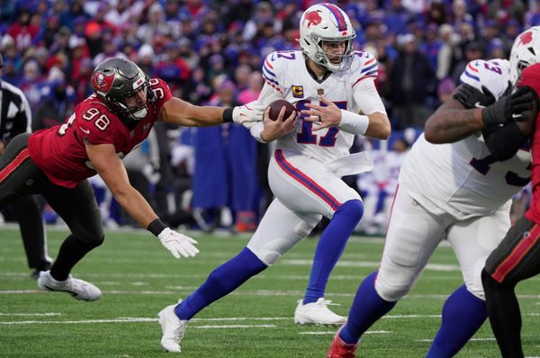 Buffalo Bills quarterback Josh Allen avoids Tampa Bay Buccaneers linebacker Anthony Nelson and runs for his third touchdown of the game during second half action against the Tampa Bay Buccaneers on Nov 16, 2025 at Highmark Stadium in Orchard Park.
