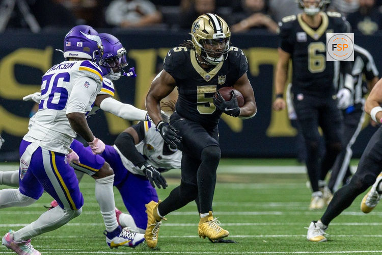 Oct 11, 2026; New Orleans, Louisiana, USA;  New Orleans Saints running back Kendre Miller (5) runs against Minnesota Vikings defensive back Theo Jackson (26) during the second half at Caesars Superdome.  Credit: Stephen Lew-Imagn Images