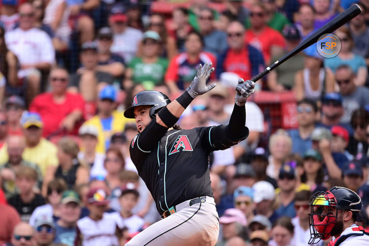 Aug 25, 2024; Boston, Massachusetts, USA; Arizona Diamondbacks third baseman Eugenio Suarez (28) hits a single during the eighth inning against the Boston Red Sox at Fenway Park. Credit: Eric Canha-USA TODAY Sports