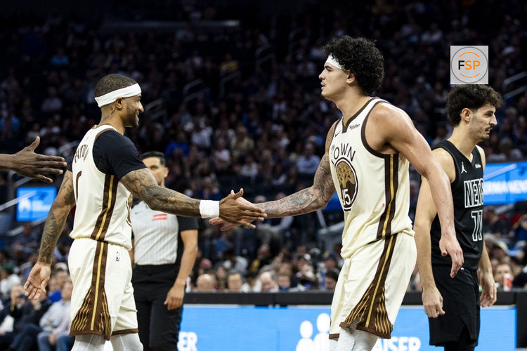 Mar 25, 2026; San Francisco, California, USA; \Golden State Warriors forward Gui Santos (15) is congratulated by guard Gary Payton II (0) after he is fouled by a Brooklyn Nets player during the fourth quarter at Chase Center. Credit: John Hefti-Imagn Images
