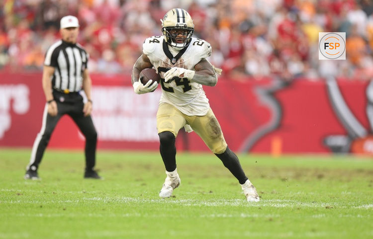 Dec 7, 2025; Tampa, Florida, USA; New Orleans Saints running back Devin Neal (24) runs for a gain during the fourth quarter against the Tampa Bay Buccaneers at Raymond James Stadium. Credit: Nathan Ray Seebeck-Imagn Images