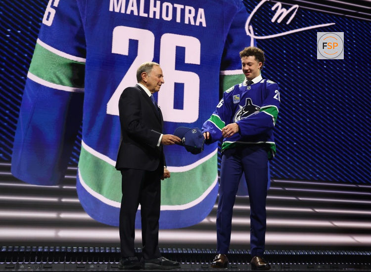 Jun 26, 2026; Buffalo, New York, USA; Caleb Malhotra reacts with NHL commissioner Gary Bettman after being selected with the third pick in the first round of the 2026 NHL Draft by the Vancouver Canucks at KeyBank Center. Credit: Timothy T. Ludwig-Imagn Images
