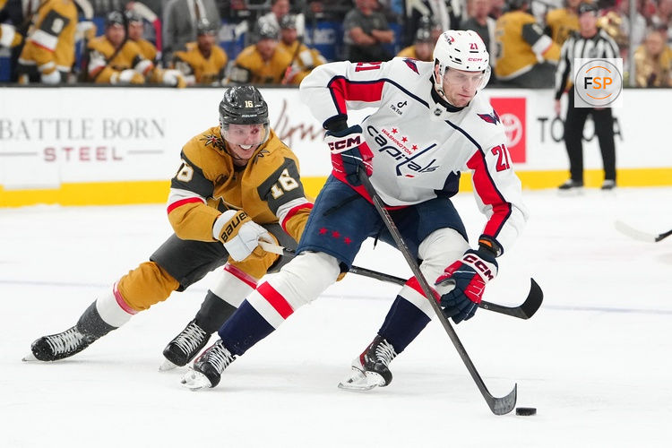Mar 28, 2026; Las Vegas, Nevada, USA; Washington Capitals left wing Aliaksei Protas (21) protects the puck from Vegas Golden Knights right wing Pavel Dorofeyev (16) during the first period at T-Mobile Arena. Credit: Stephen R. Sylvanie-Imagn Images