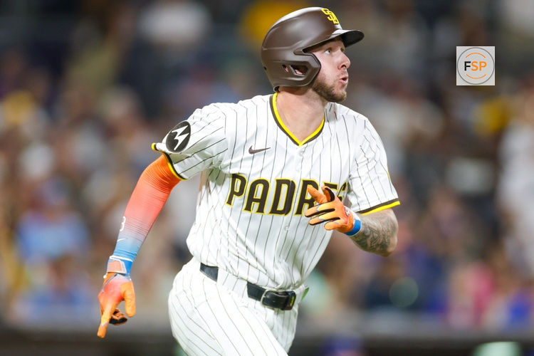 Jul 5, 2025; San Diego, California, USA; San Diego Padres center fielder Jackson Merrill (3) hits a sacrifice fly during the seventh inning against the Texas Rangers at Petco Park. Credit: David Frerker-Imagn Images