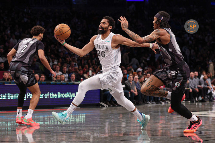 Mar 24, 2025; Brooklyn, New York, USA; Dallas Mavericks guard Spencer Dinwiddie (26) goes to the basket against Brooklyn Nets forward Maxwell Lewis (27) during the second half at Barclays Center. Credit: Vincent Carchietta-Imagn Images