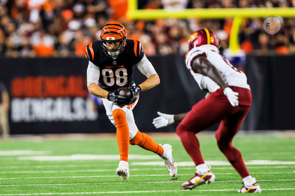 Sep 23, 2024; Cincinnati, Ohio, USA; Cincinnati Bengals tight end Mike Gesicki (88) runs with the ball Washington Commanders cornerback Mike Sainristil (0) in the second half at Paycor Stadium. Credit: Katie Stratman-Imagn Images