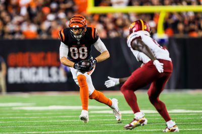 Sep 23, 2024; Cincinnati, Ohio, USA; Cincinnati Bengals tight end Mike Gesicki (88) runs with the ball Washington Commanders cornerback Mike Sainristil (0) in the second half at Paycor Stadium. Mandatory Credit: Katie Stratman-Imagn Images