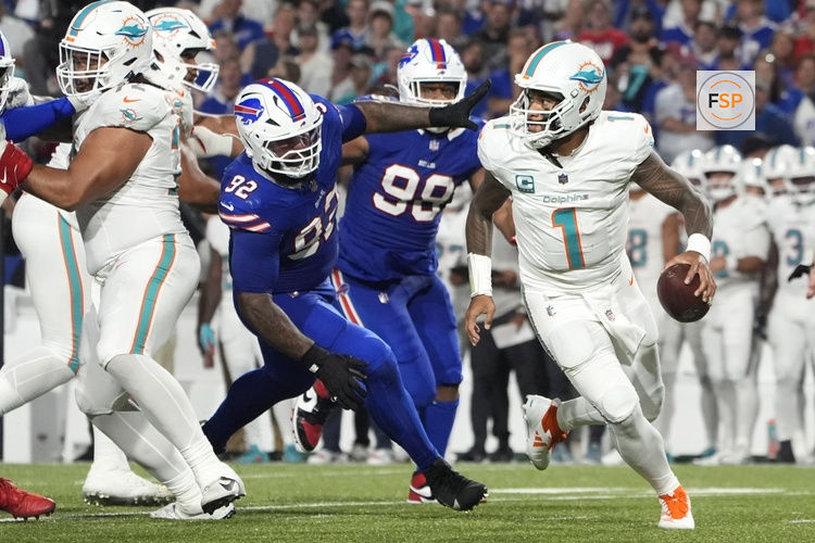 Sep 18, 2025; Orchard Park, New York, USA; Miami Dolphins quarterback Tua Tagovailoa (1) looks to pass against Buffalo Bills defensive tackle Daquan Jones (92) in the third quarter at Highmark Stadium. Credit: Gregory Fisher-Imagn Images