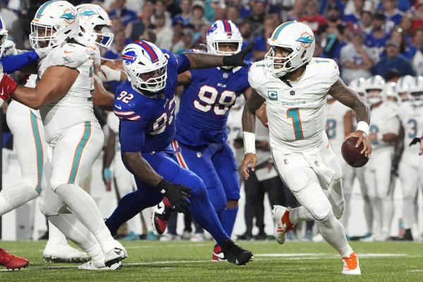 Sep 18, 2025; Orchard Park, New York, USA; Miami Dolphins quarterback Tua Tagovailoa (1) looks to pass against Buffalo Bills defensive tackle Daquan Jones (92) in the third quarter at Highmark Stadium. Mandatory Credit: Gregory Fisher-Imagn Images