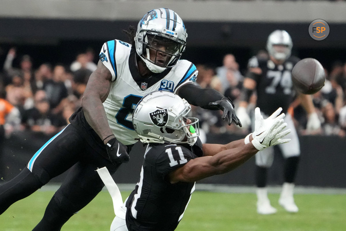 Sep 22, 2024; Paradise, Nevada, USA; Las Vegas Raiders wide receiver Tre Tucker (11) attempts to catch the ball against Carolina Panthers cornerback Jaycee Horn (8) in the second half at Allegiant Stadium. Credit: Kirby Lee-Imagn Images