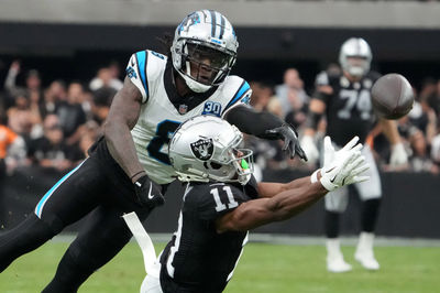 Sep 22, 2024; Paradise, Nevada, USA; Las Vegas Raiders wide receiver Tre Tucker (11) attempts to catch the ball against Carolina Panthers cornerback Jaycee Horn (8) in the second half at Allegiant Stadium. Mandatory Credit: Kirby Lee-Imagn Images