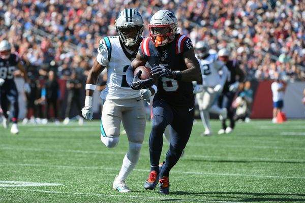 Sep 28, 2025; Foxborough, Massachusetts, USA; New England Patriots wide receiver Stefon Diggs (8) runs with the ball while Carolina Panthers cornerback Mike Jackson (2) defends during the first half at Gillette Stadium. Mandatory Credit: Bob DeChiara-Imagn Images