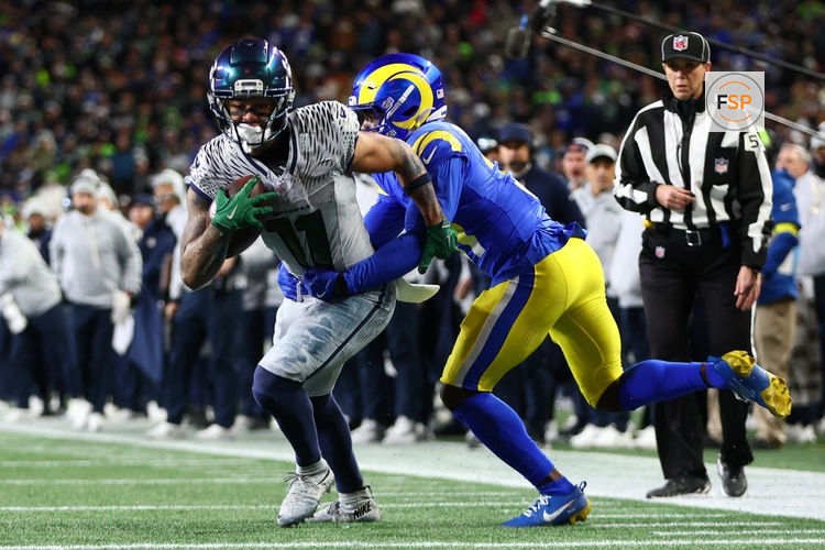 Dec 18, 2025; Seattle, Washington, USA; Seattle Seahawks wide receiver Jaxon Smith-Njigba (11) runs against Los Angeles Rams cornerback Darious Williams (31) in the second half at Lumen Field. Credit: Kevin Ng-Imagn Images
