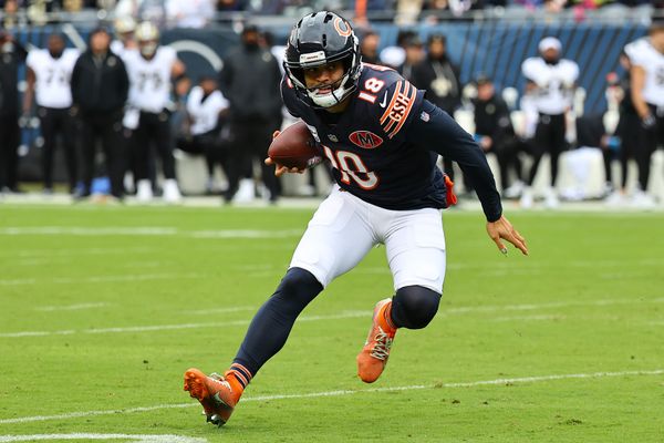 Oct 19, 2025; Chicago, Illinois, USA; Chicago Bears quarterback Caleb Williams (18) rushes the ball against the New Orleans Saints during the first quarter at Soldier Field. Mandatory Credit: Mike Dinovo-Imagn Images