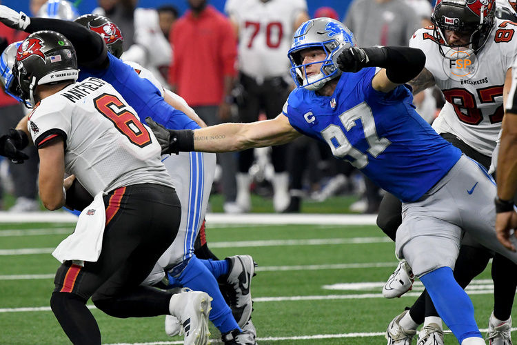 Sep 15, 2024; Detroit, Michigan, USA; Detroit Lions defensive end Aidan Hutchinson (97) attempts to tackle Tampa Bay Buccaneers quarterback Baker Mayfield (6) in the fourth quarter at Ford Field. Credit: Eamon Horwedel-Imagn Images