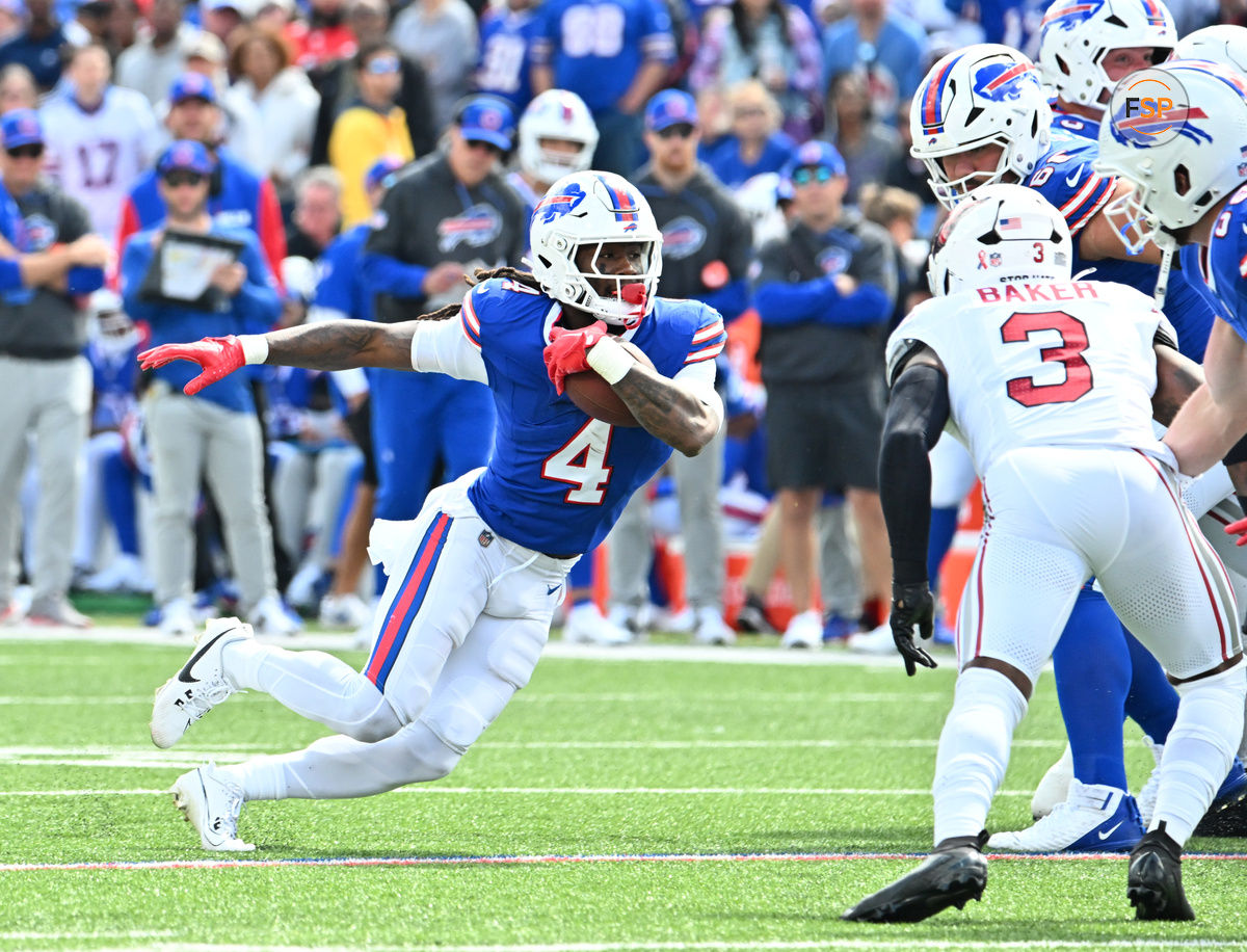 Sep 8, 2024; Orchard Park, New York, USA; Buffalo Bills running back James Cook (4) runs against Arizona Cardinals safety Budda Baker (3) in the second quarter at Highmark Stadium. Credit: Mark Konezny-Imagn Images