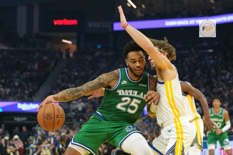 Dec 25, 2025; San Francisco, California, USA; Dallas Mavericks forward P.J. Washington (25) dribbles against Golden State Warriors guard Brandin Podziemski (center right) during the first quarter at Chase Center. Credit: Darren Yamashita-Imagn Images