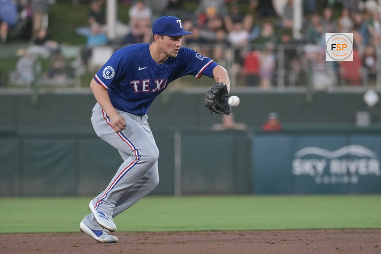 Apr 22, 2025; West Sacramento, California, USA; Texas Rangers shortstop Corey Seager (5) fields the ball during the second inning of the game against the Athletics at Sutter Health Park. Credit: Ed Szczepanski-Imagn Images