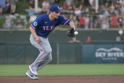Apr 22, 2025; West Sacramento, California, USA; Texas Rangers shortstop Corey Seager (5) fields the ball during the second inning of the game against the Athletics at Sutter Health Park. Mandatory Credit: Ed Szczepanski-Imagn Images