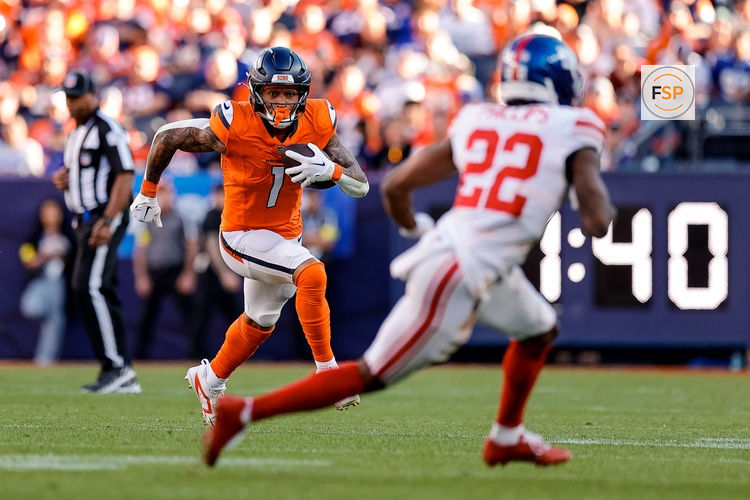 Oct 19, 2025; Denver, Colorado, USA; Denver Broncos tight end Evan Engram (1) runs the ball as New York Giants cornerback Dru Phillips (22) defends in the third quarter at Empower Field at Mile High. Credit: Isaiah J. Downing-Imagn Images