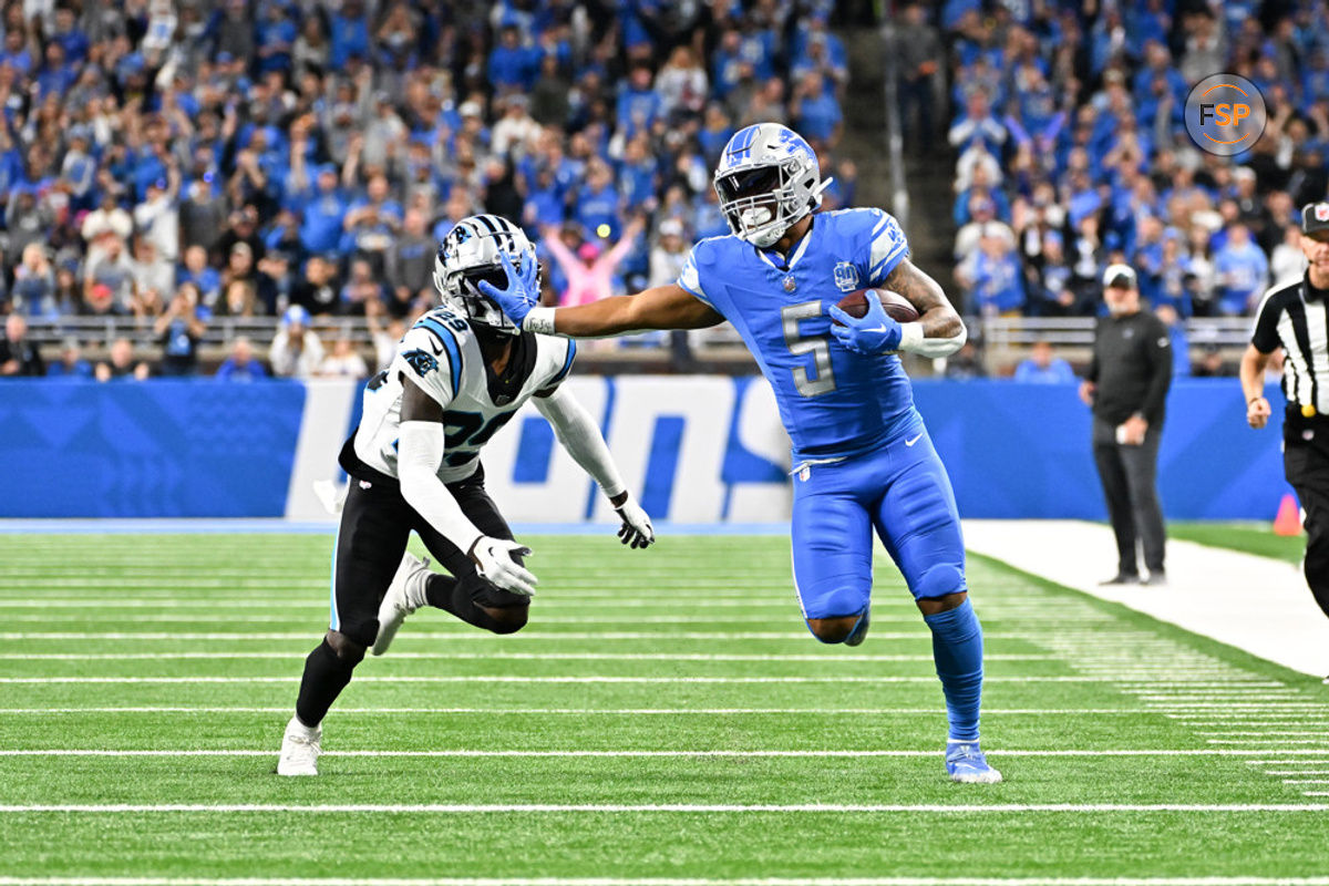 DETROIT, MI - OCTOBER 08: Detroit Lions running back David Montgomery (5) breaks to the outside for a long touchdown run while stiff arming Carolina Panthers cornerback D'Shawn Jamison (29) during the Detroit Lions versus the Carolina Panthers game on Sunday October 8, 2023 at Ford Field in Detroit, MI. (Photo by Steven King/Icon Sportswire)