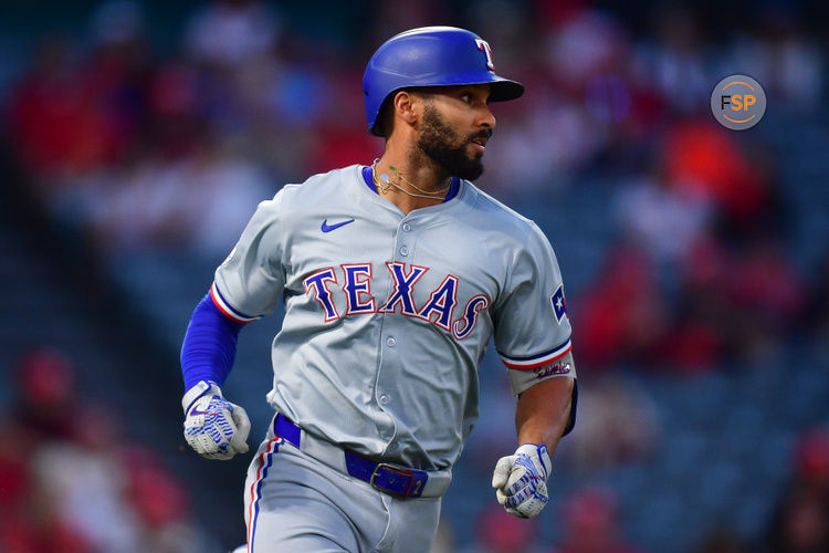 Sep 27, 2024; Anaheim, California, USA; Texas Rangers second baseman Marcus Semien (2) runs after hitting a single against the Los Angeles Angels during the first inning at Angel Stadium. Credit: Gary A. Vasquez-Imagn Images